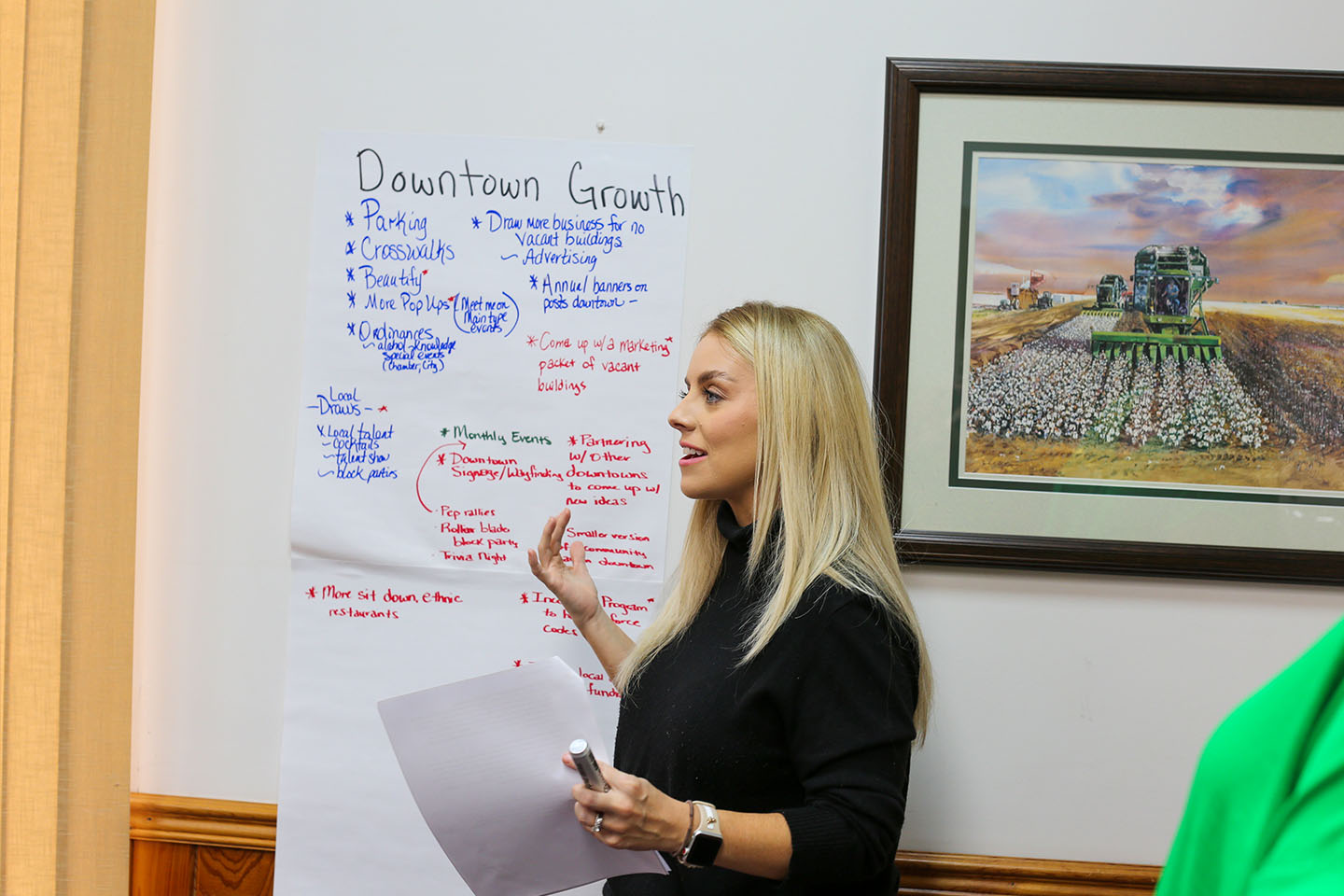 woman talking presenting about flip chart labelled downtown growth