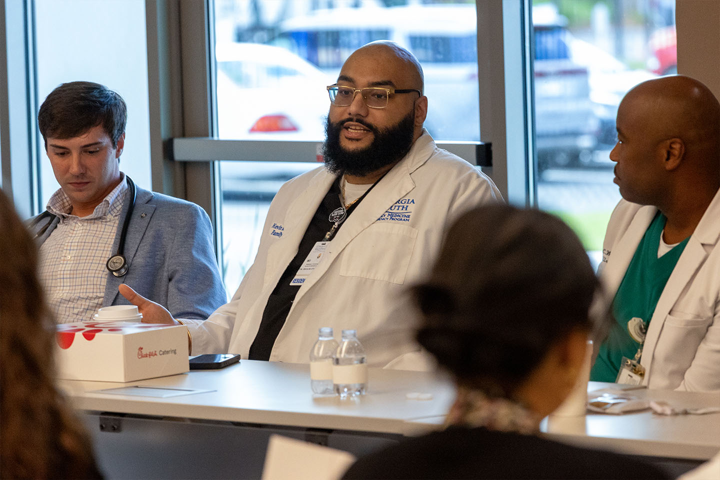 a doctor speaks on a panel of physicians