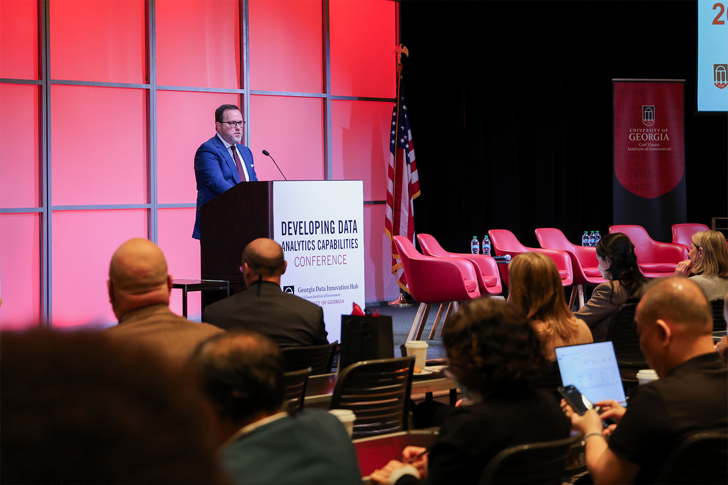 presenter at podium at large conference