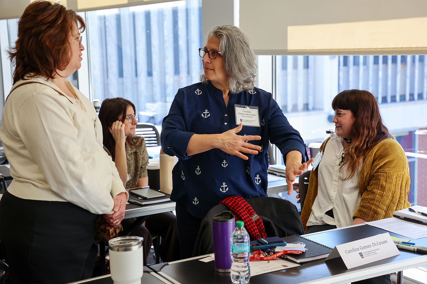 three female faculty collaborate at a workshop setting
