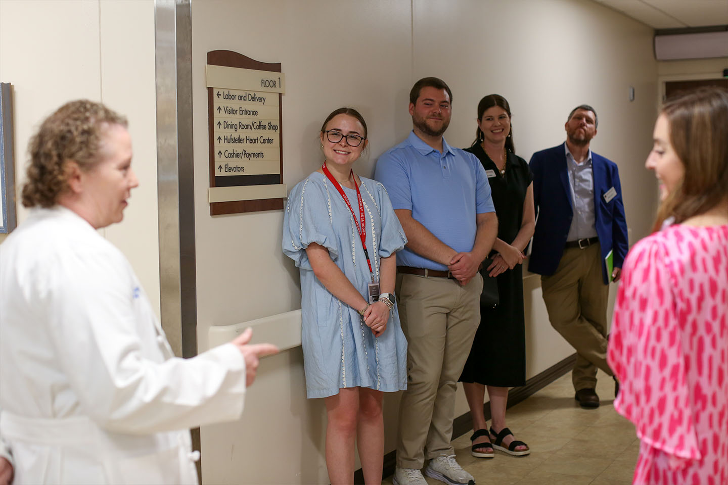 Cassidy listens to a physician in a rural hospital with other students and staff members