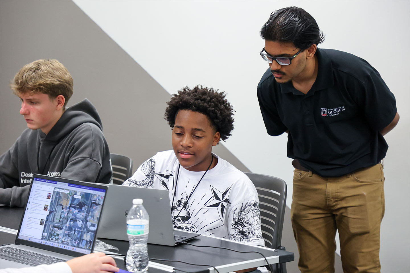 CyberArch student helps camper with computer project