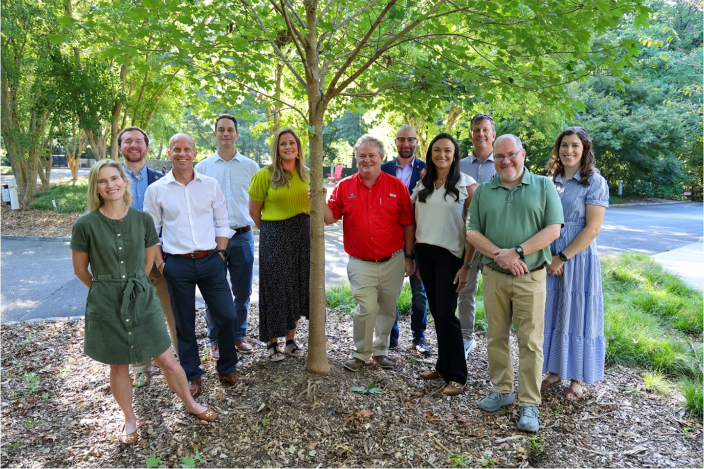 group photo of grow back participants from public service and outreach next to a tree