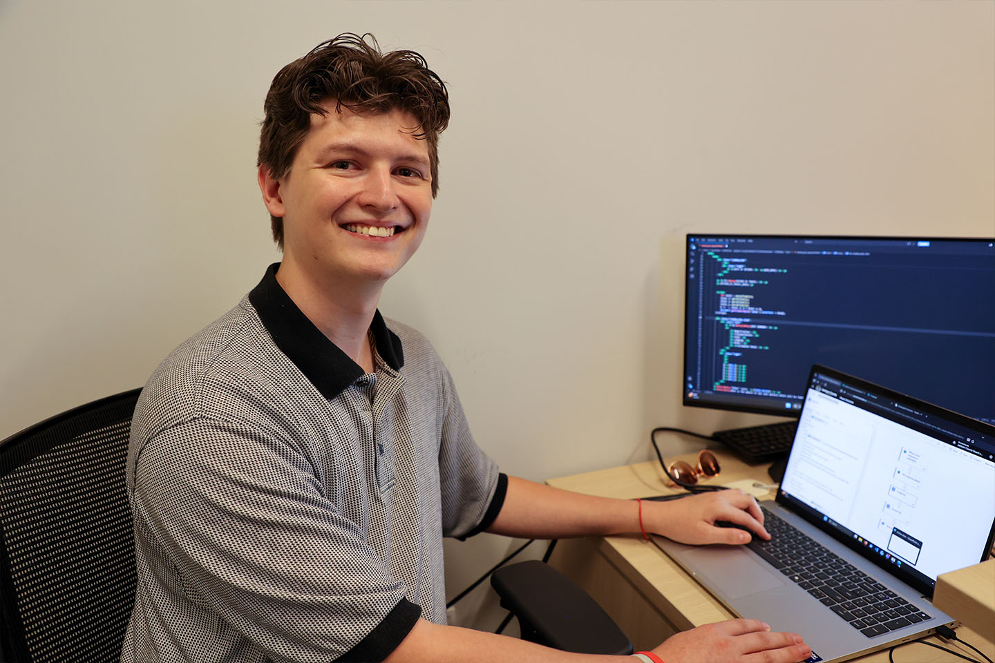 Christopher Youmans working on a laptop at a desk
